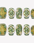 Emerald Crown press-on nails with glossy green bases, faceted green gems, pearl borders, gold beads, and glitter accents