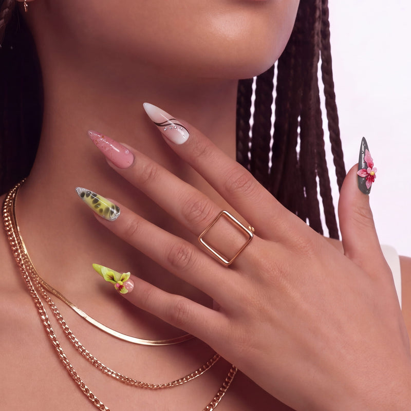 Close-up of a hand wearing multicolor floral press-on nails with pink, yellow, and green accents.