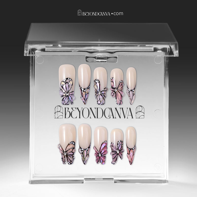 Press-on nails displayed inside a clear BeyondCanva case with pale pink butterfly wing designs