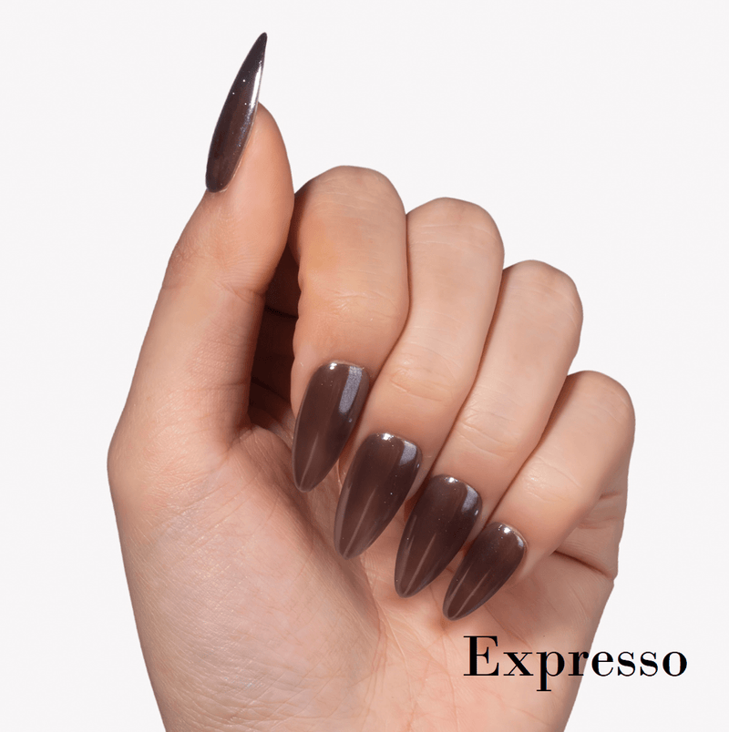 Hand model wearing Fall Essence Espresso press-on nails in a dark espresso brown shade with glossy almond-shaped tips