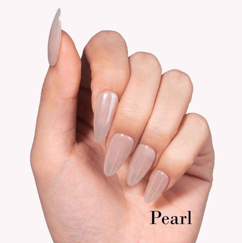 Hand model wearing Fall Essence Pearl press-on nails in a sheer nude pearl shade with glossy almond-shaped tips