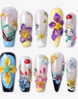 Floral Symphony press-on nails with 3D flowers, mushroom accents, rhinestones, and colorful glossy tips