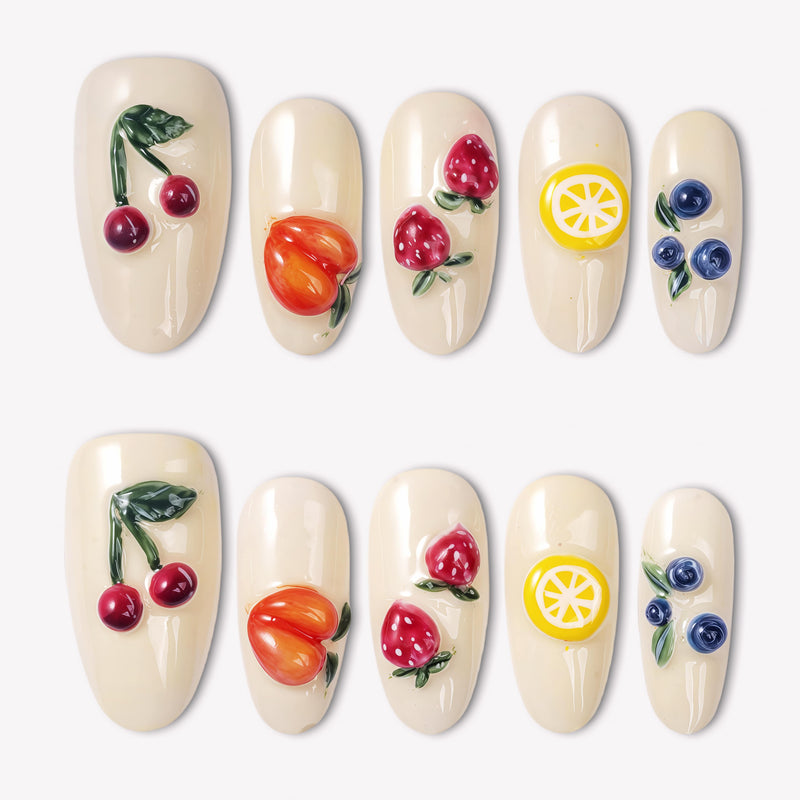 Fruit Crush cream press-on nails with glossy 3D cherries, peach, strawberries, lemon, and blueberries in a white flat lay