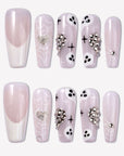 Ghosted Love press-on nails with pink translucent bases, white spider webs, ghost faces, silver heart rhinestones, and star accents