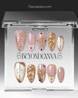 Clear BeyondCanva box displaying blush pink and gold jeweled press-on nails.