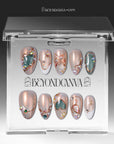 A set of champagne shimmer press-on nails displayed in a clear BeyondCanva box package