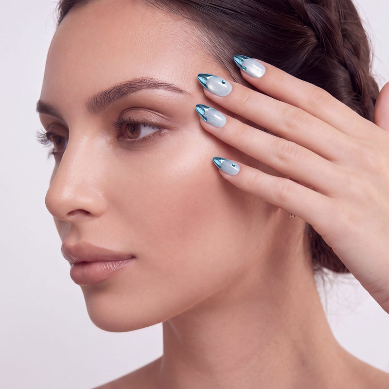 Silver and blue chrome press-on nails arranged in a flat lay