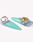 Closeup of Glacier Jewel press-on nails with mint blue ombré and oversized yellow and clear gemstone accents