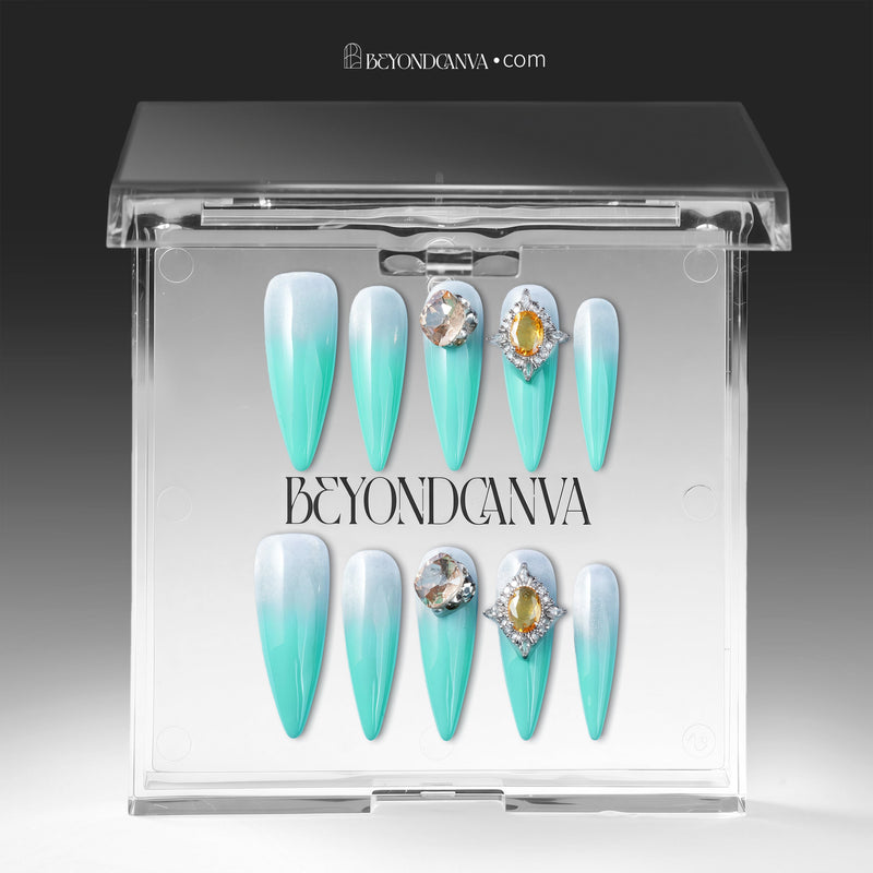 Glacier Jewel press-on nails displayed in a clear BeyondCanva case with icy blue ombré and yellow crystal embellishments
