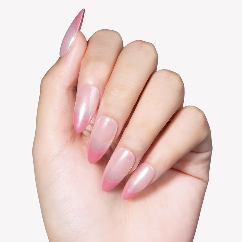 Hand model wearing Glazed French almond press-on nails with pearly nude bases and translucent pink French tips