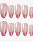 Glazed French press-on nails with pearly nude bases and glossy pink glitter French tips in a white flat lay