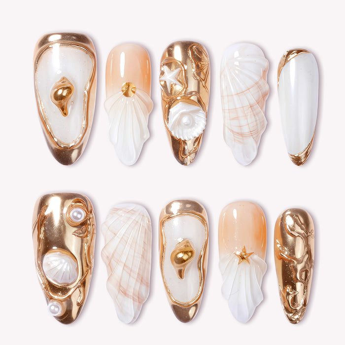 Golden Shell white and gold press-on nails with raised seashell charms, pearls and metallic accents