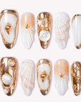 Golden Shell white and gold press-on nails with raised seashell charms, pearls and metallic accents