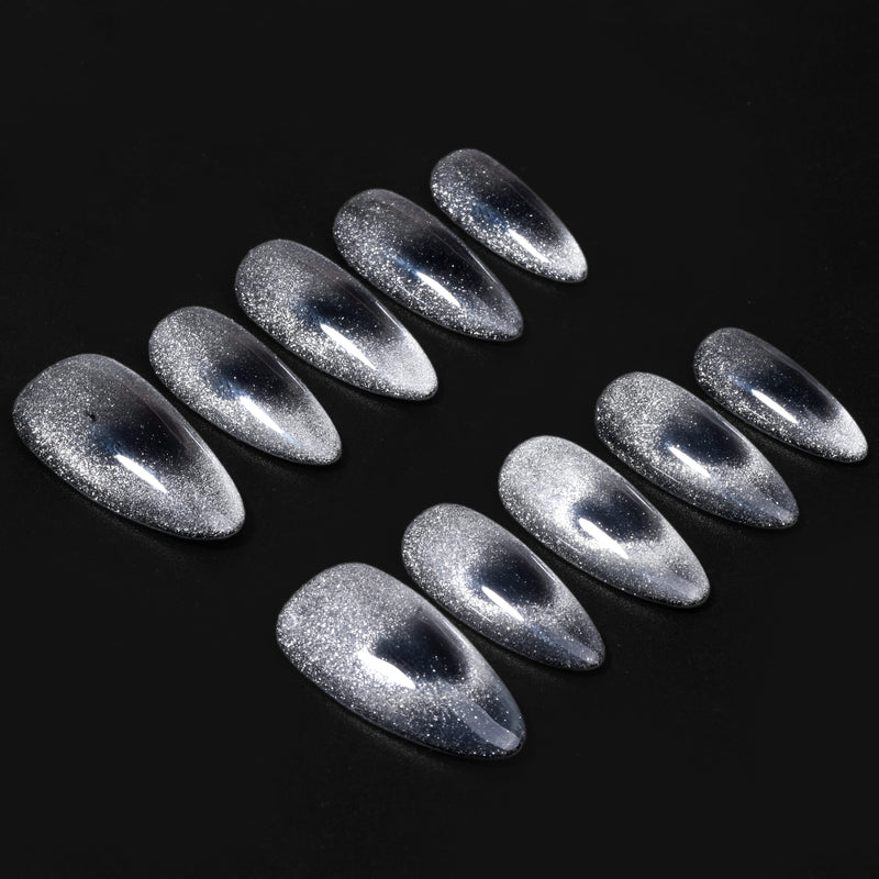 Gravity silver glitter cat-eye almond press-on nails arranged on a dramatic black background