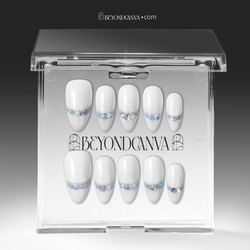 Press-on nails displayed in a clear BeyondCanva case with white nails and iridescent chrome shimmer accents.