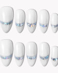 Flat lay of white press-on nails with iridescent chrome shimmer accents on a white background.