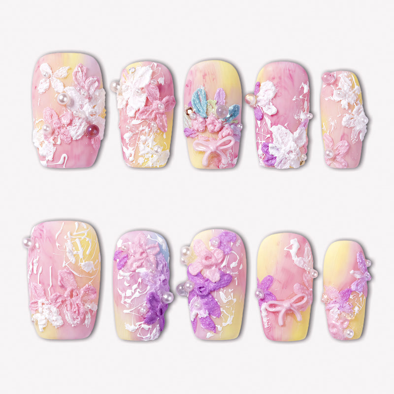 Impressionist Pointe press-on nails with pink and yellow gradients, 3D flowers, pearls, and bow accents