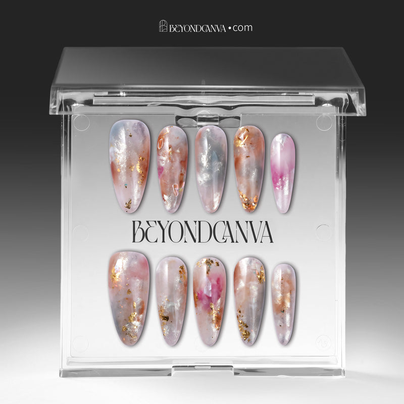Iridescent pearl press-on nails displayed in clear packaging with silver, blush pink, and gold foil accents