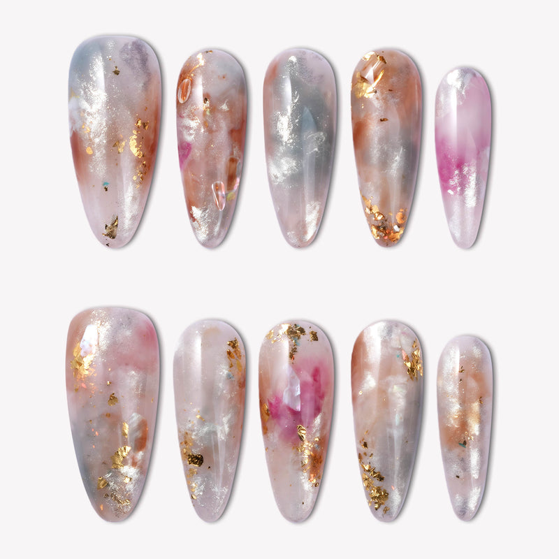 Flat lay of iridescent pearl press-on nails in silver, blush pink, and gold foil on a white background