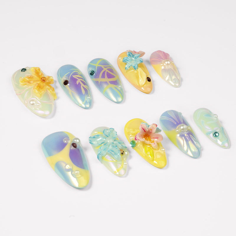Angled flat lay of Iridescent Petals pastel iridescent nails with sculpted flowers, pearls and jewel accents