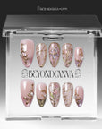 Clear BeyondCanva box displaying blush pink and gold floral press-on nails with stained-glass line art.