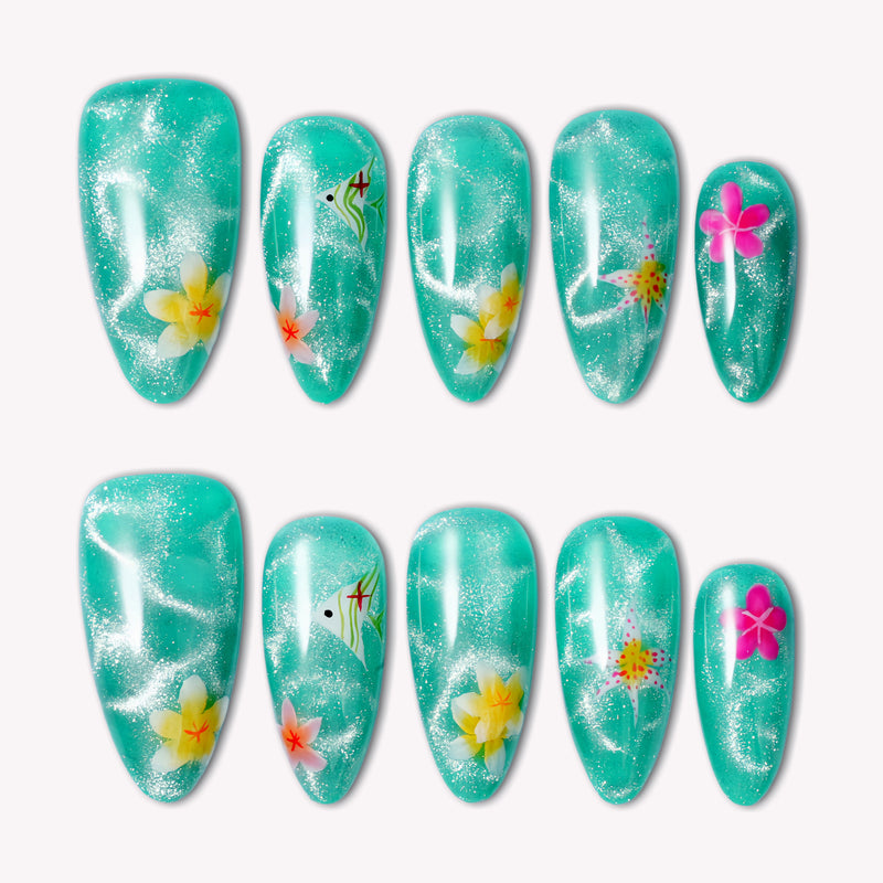 Island Lagoon handmade press-on nails in shimmering turquoise with tropical flower accents, arranged on a white background.