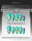 Press-on nails displayed inside a clear BeyondCanva case with turquoise glitter floral nails