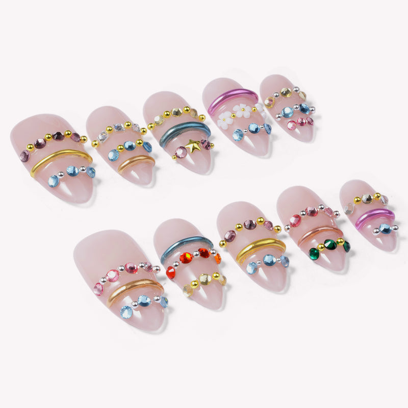 Jewel Band handmade press-on nails flat lay showing nude nails with multicolor gemstone bands and metallic rings