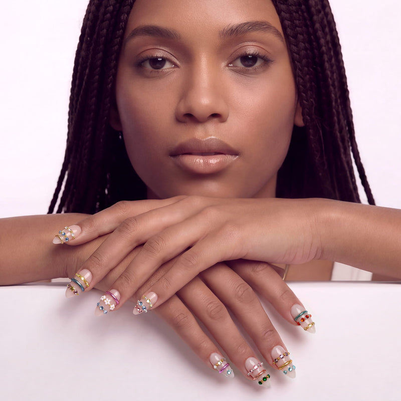 Jewel Band handmade press-on nails on a hand model with nude bases and multicolor gemstone ring accents