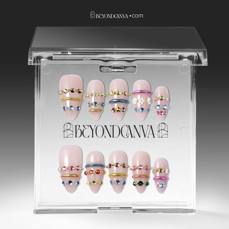 Jewel Band handmade press-on nails displayed in a clear case with multicolor gemstone bands and nude bases