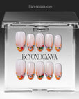 Jewel Sunset press-on nails displayed in clear packaging with ruby red tips, orange accents, and multicolor gem details