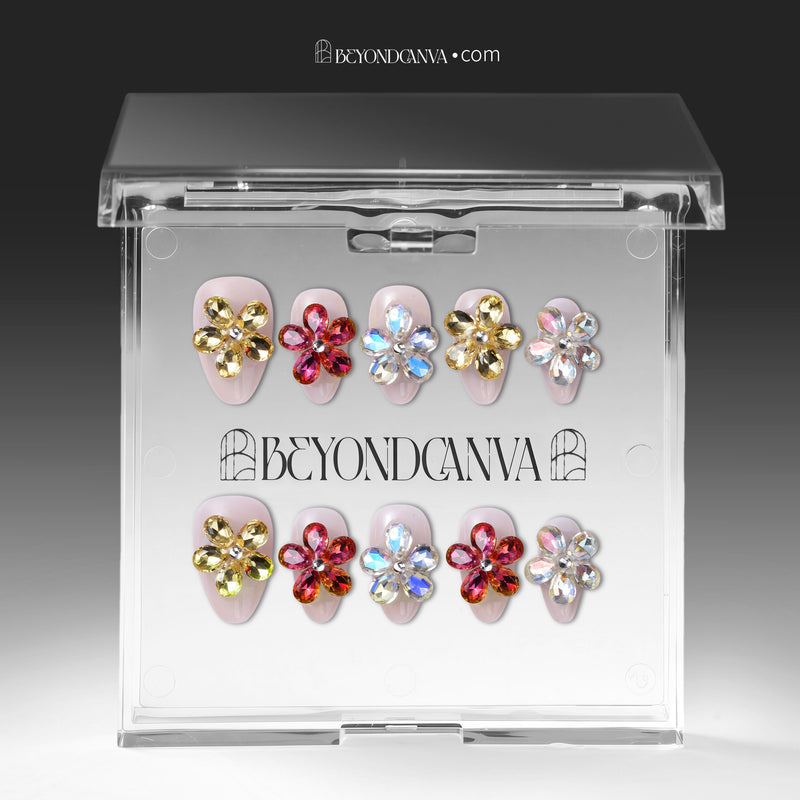 Jeweled floral press-on nails displayed inside a clear storage box.