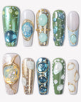 Jungle Relic green, blue, ivory and gold press-on nails with raised translucent gemstone details in a flat lay