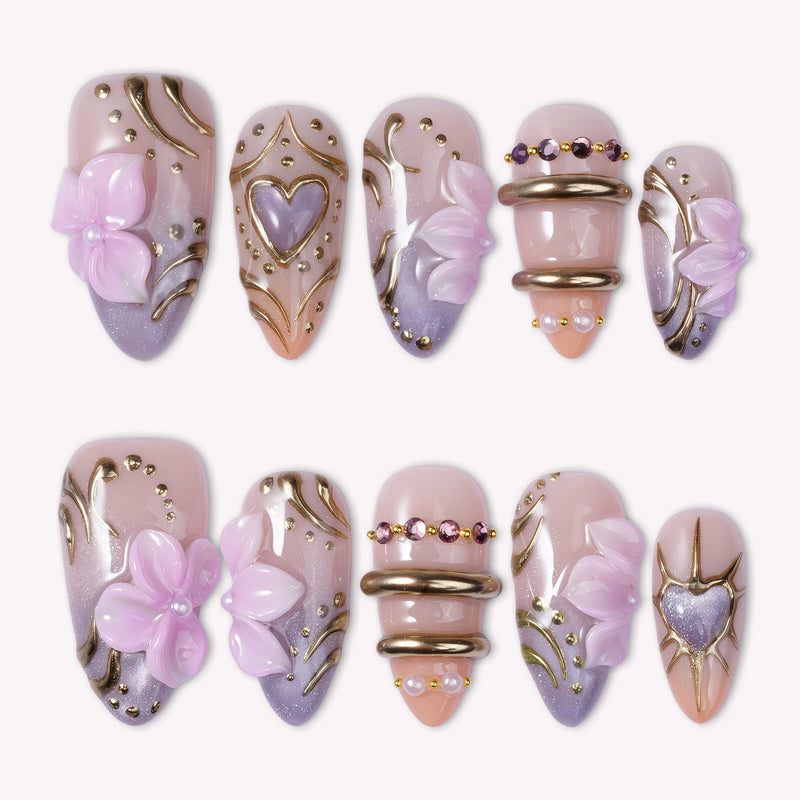 Lavender Lyric handmade press on nails in a white flat lay with lavender, blush pink, gold accents, and floral details