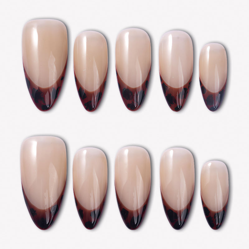 Leopard French press-on nails with glossy nude bases and deep brown black animal print French tips arranged in a full set