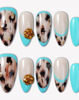 Flat lay of Luxe Savannah press-on nail swatches with turquoise tips, cream bases, black animal print, and gold flower accents