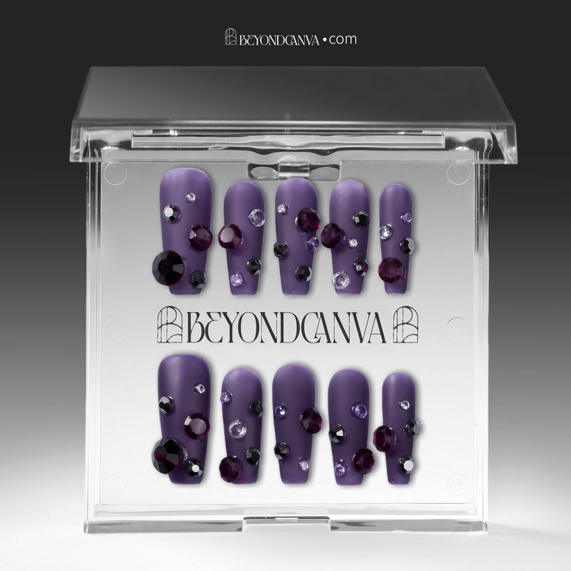 Packaging display of Luxurious Treasure purple square press-on nails in a clear BeyondCanva case with dark purple, black, and clear rhinestone gems