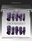 Packaging display of Luxurious Treasure purple square press-on nails in a clear BeyondCanva case with dark purple, black, and clear rhinestone gems