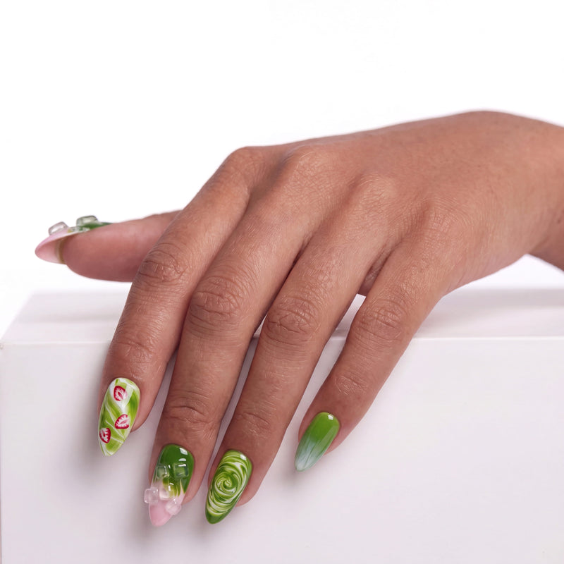 Matcha &amp; Boba handmade press on nails shown on the back of a hand with green fruit and swirl accents