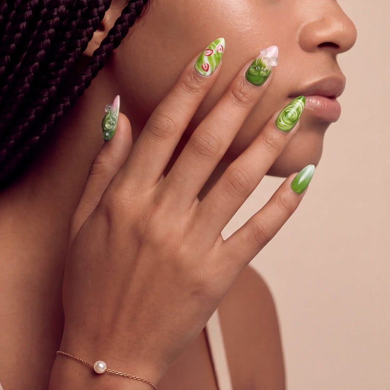 Matcha & Boba handmade press on nails worn on a hand model in a close-up portrait with green swirl and berry accents