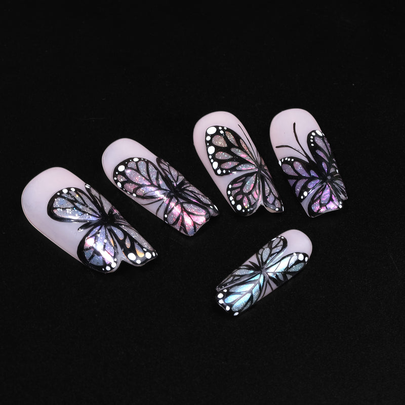 Midnight Monarch irregular shaped handmade press-on nails flat lay on a black background with iridescent butterfly wing designs