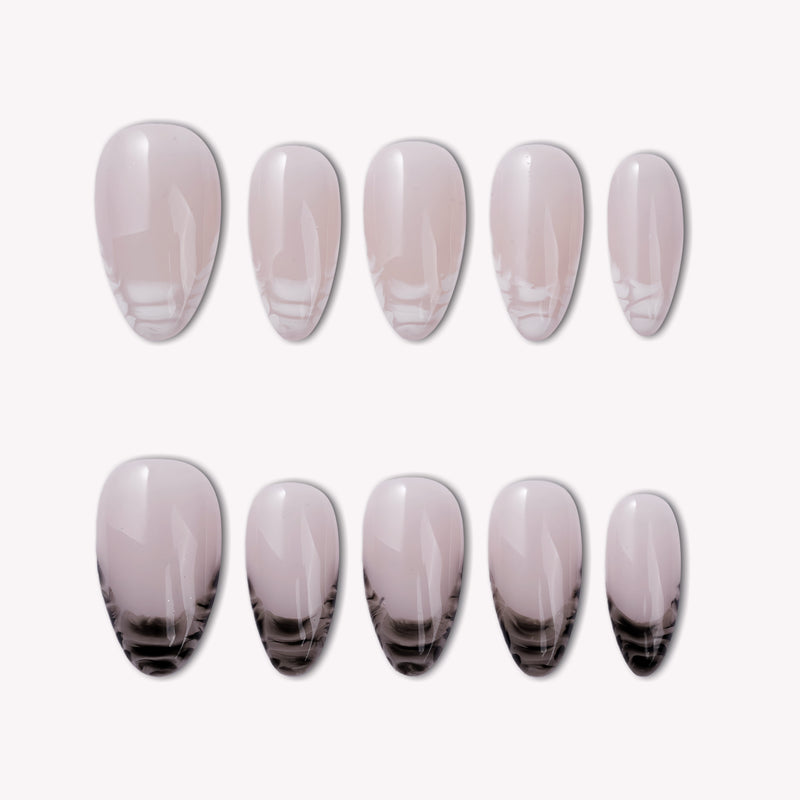 Mist Fade press-on nail set in nude gray with black smoky gradient tips arranged on a white background