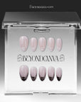 Mist Fade press-on nails in nude gray with smoky black-and-white tips displayed in a clear packaging box