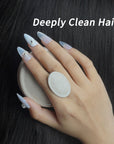 Nail-friendly scalp massager brush used on dark hair by a hand with long blue press-on nails for deep cleansing