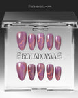Nebula Kiss purple and pink cat-eye heart press-on nails displayed in a clear Beyondcanva storage case