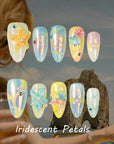 Iridescent Petals press-on nails style card with blue, yellow and pearl floral designs and rhinestone accents