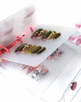 Open binder display showing multiple 9 to 9 Chic press-on nail sets with metallic, floral and rhinestone details
