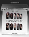 Nocturne Gild press-on nails in glossy black with metallic gold foil accents displayed in a clear packaging box