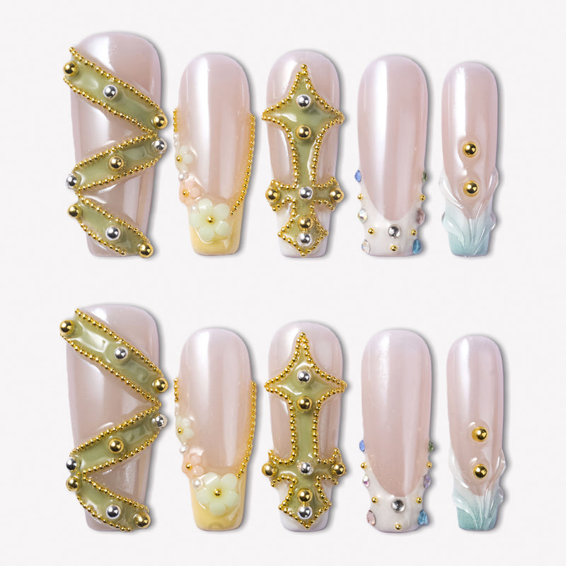 Opal Dynasty press-on nails with nude pink bases, gold crown and cross accents, pearl flowers, rhinestones, and blue translucent tips