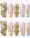 Opal Dynasty press-on nails with nude pink bases, gold crown and cross accents, pearl flowers, rhinestones, and blue translucent tips